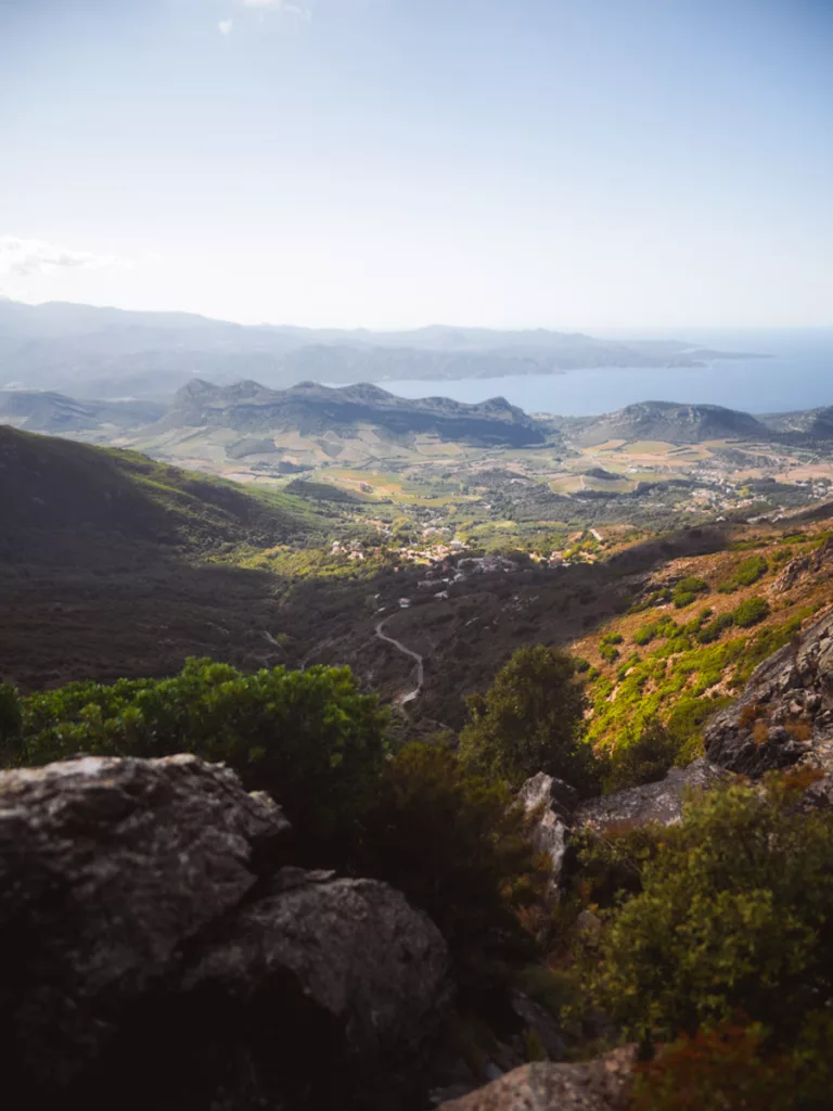 Village de Patrimonio au pied du Cap Corse vue depuis les montagnes du col de Teghime en Haute-Corse.