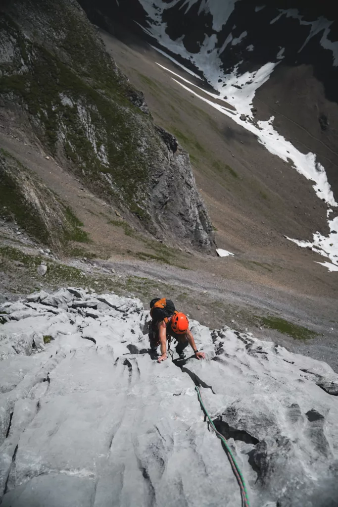 Grimpeuse sur des cannelures dans une grande voie dans les Aravis en Haute-Savoie (tonneau des Danaïdes)